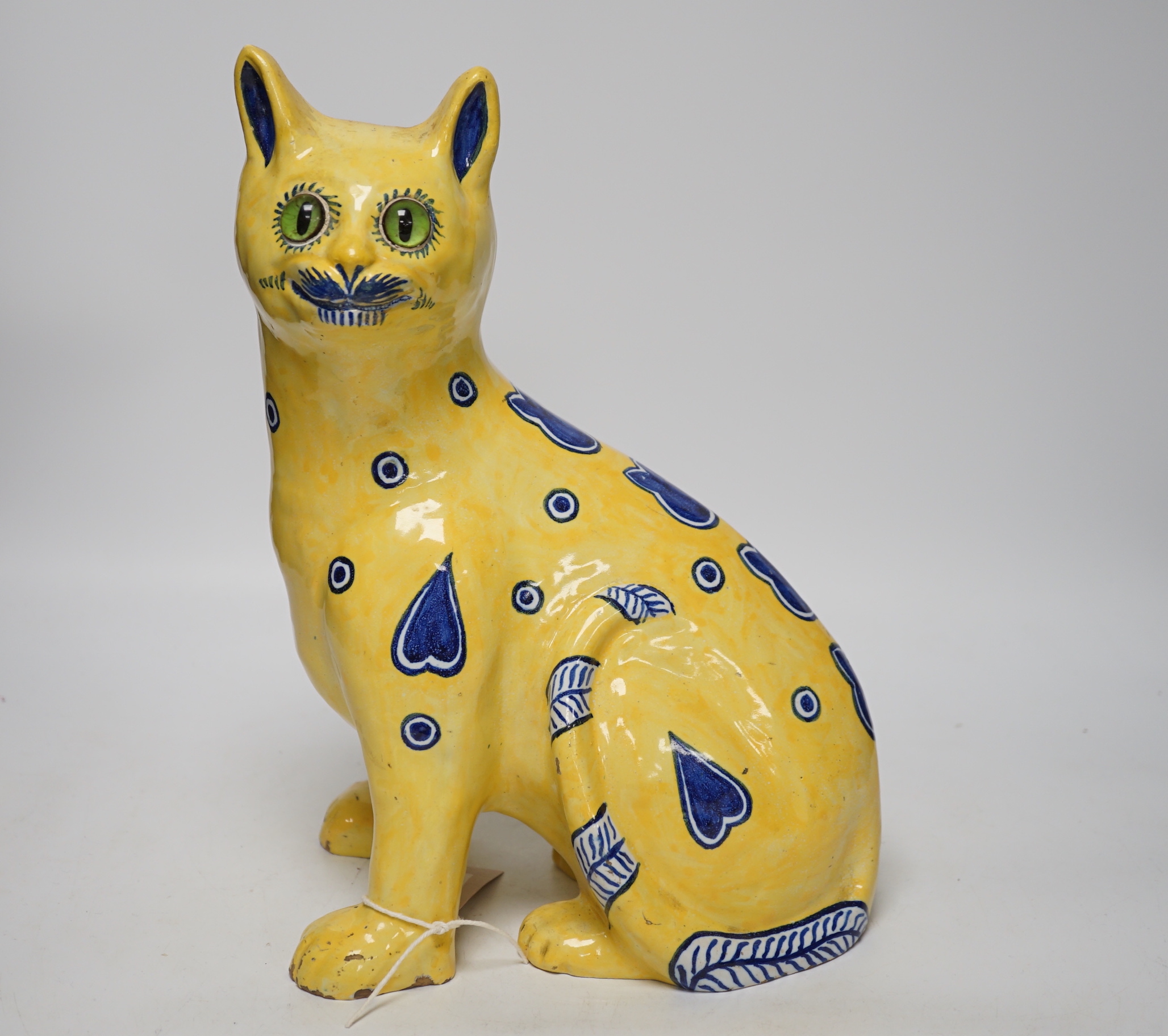 A Mosanic Galle style faience seated cat with glass eyes, c.1900-10, 31cm